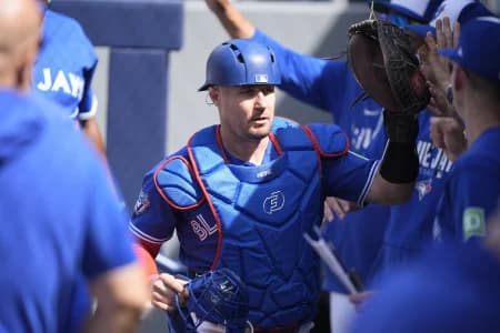 Toronto Blue Jays catcher Tyler Heineman (55) gets congratulated in the dugout after throwing out Miami Marlins center fielder Jakob Marsee (not pictured) at second base during the eighth inning at Rogers Centre.
