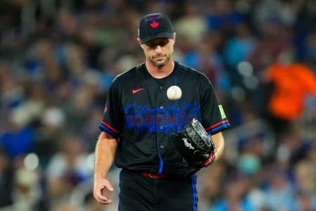 Toronto Blue Jays pitcher Max Scherzer (31) juggles the ball at a MLB game against the Cleveland Guardians at Rogers Centre.