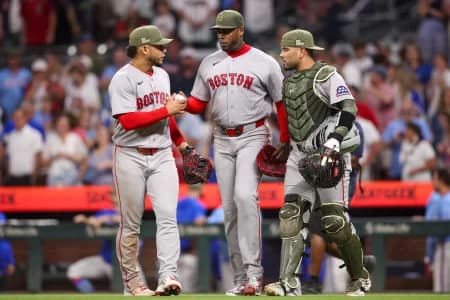Boston Red Sox first baseman Willson Contreras (40) and pitcher Aroldis Chapman (44) and catcher Carlos Narvaez (75) celebrate after a victory over the Atlanta Braves at Truist Park.