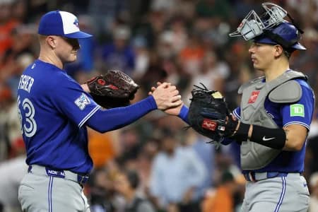 Toronto Blue Jays pitcher Braydon Fisher (63) celebrates with Toronto Blue Jays catcher Brandon Valenzuela (59) after a game against the Baltimore Orioles at Oriole Park at Camden Yards.