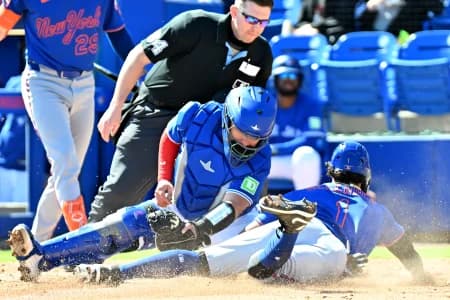 Toronto Blue Jays catcher Alejandro Kirk (30) tags out New York Mets right fielder MJ Melendez (1) on a steal attempt in the third inning during spring training at TD Ballpark.