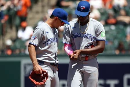 Toronto Blue Jays right fielder Jesus Sanchez (12) speaks to Toronto Blue Jays shortstop Andres Gimenez (0) during the sixth inning against the Baltimore Orioles at Oriole Park at Camden Yards.