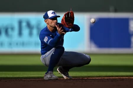 Toronto Blue Jays infielder Andres Gimenez (0) fields a ground ball in the eighth inning against the Baltimore Orioles at Oriole Park at Camden Yards.