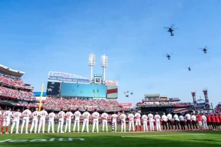 Three AH-64 Apache helicopters and one UH-60 Blackhawk helicopter from 1st Battalion, 101st Aviation Regiment, out of Fort Campbell, Kentucky, fly over during the National Anthem before the first inning of the MLB Opening Day game between the Cincinnati Reds and the Boston Red Sox at Great American Ball Park in downtown Cincinnati on Thursday, March 26, 2026. The game was tied at 0 after four innings.