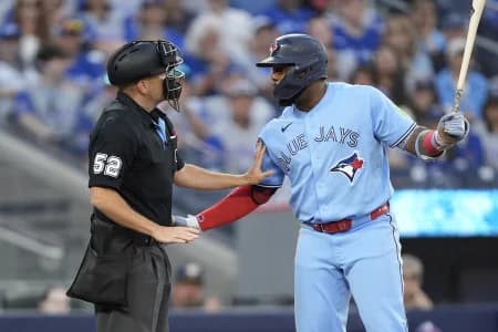 Home plate umpire Jansen Visconti talks to Toronto Blue Jays first baseman Vladimir Guerrero Jr. (27) after a pitch from the Philadelphia Phillies during the fourth inning at Rogers Centre.