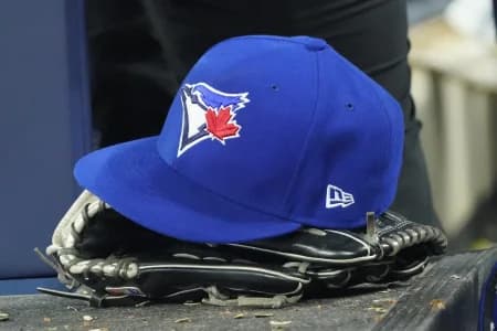A Toronto Blue Jays hat and glove in the dugout during the third inning against the Los Angeles Dodgers at Rogers Centre.