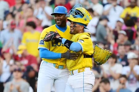 Boston Red Sox pitcher Aroldis Chapman (44) and catcher Carlos Narváez (75) smile after defeating the Texas Rangers at Fenway Park.