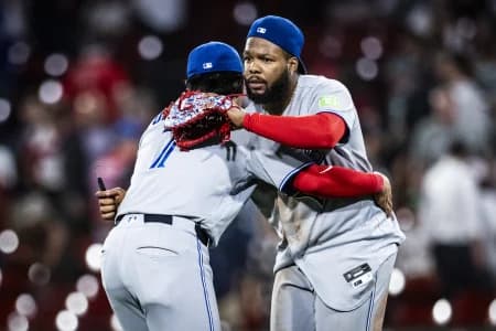 Toronto Blue Jays third baseman Kazuma Okamoto (7) and first baseman Vladimir Guerrero Jr. (27) embrace after their ninth inning win over the Boston Red Sox at Fenway Park.