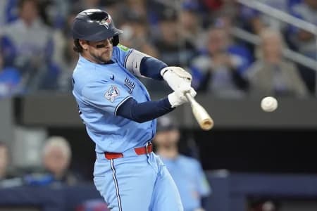 Toronto Blue Jays second baseman Ernie Clement (22) hits a single against the Philadelphia Phillies during the seventh inning at Rogers Centre