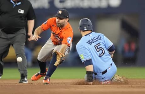 Toronto Blue Jays center fielder Daulton Varsho (5) steals second base against Houston Astros second baseman Jose Altuve (27) during the seventh inning at Rogers Centre.