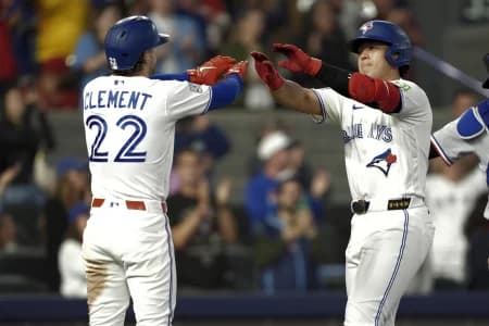 Toronto Blue Jays shortstop Ernie Clement (22) congratulates third baseman Kazuma Okamoto (7) on his two run home run against the Texas Rangers during the ninth inning at Rogers Centre