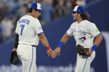 Toronto Blue Jays third baseman Kazuma Okamoto (7) and right fielder Addison Barger (47) celebrate a win over the Athletics at Rogers Centre.
