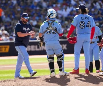 Toronto Blue Jays manager John Schneider (14) walks to the mound to relieve Toronto Blue Jays pitcher Dylan Cease (84) during the fifth inning at Rogers Centre