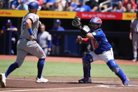 Toronto Blue Jays catcher Alejandro Kirk (30) gets Texas Rangers third baseman Josh Jung (6) out on a force play at home plate during the first inning at Rogers Centre.