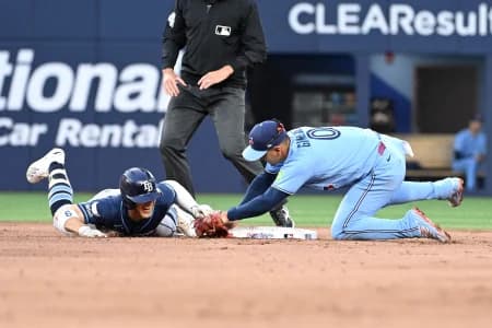 Toronto Blue Jays shortstop Andres Gimenez (0) tags out Tampa Bay Rays shortstop Taylor Walls (5) after Walls tried to stretch a double in the fifth inning at Rogers Centre.
