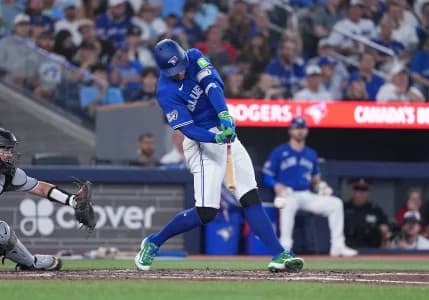 Toronto Blue Jays designated hitter George Springer (4) hits an RBI single against the Chicago White Sox during the fourth inning at Rogers Centre