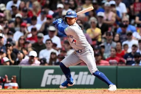 Toronto Blue Jays shortstop Andrés Giménez (0) hits a RBI single against the Boston Red Sox during the ninth inning at Fenway Park.