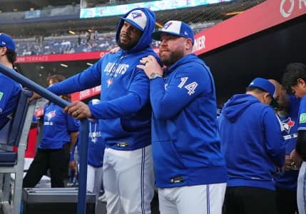 Toronto Blue Jays first baseman Vladimir Guerrero Jr. (27) talks with manager John Schneider (14) before the start of a game against the Miami Marlins at the Rogers Centre.