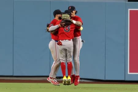 Boston Red Sox center fielder Ceddanne Rafaela (3) celebrates a win with right fielder Wilyer Abreu (52) and left fielder Jarren Duran (16) after defeating the Los Angeles Dodgers 9-4 at Dodger Stadium.