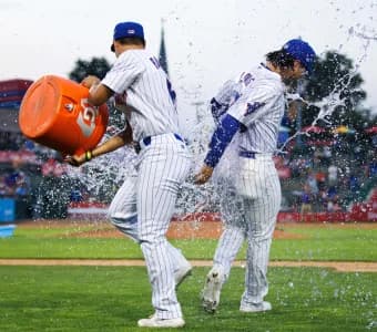 South Bend Cubs outfielder Brett Bateman, left, throws water on infielder Jonathon Long after winning a minor league baseball 4-3 against the Lake County Captains game at Four Winds Field on Friday, June 21, 2024, in South Bend.