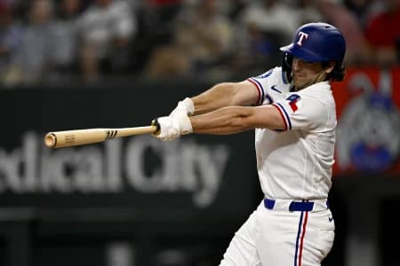 Texas Rangers second baseman Josh Smith (8) hits a single against the Los Angeles Angels during the third inning at Globe Life Field.