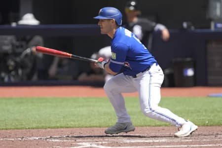 Toronto Blue Jays center fielder Daulton Varsho (5) singles against the Chicago White Sox during the seventh inning at Rogers Centre.