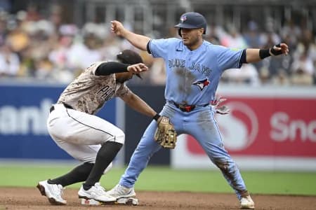 Toronto Blue Jays center fielder Daulton Varsho (5) steals second base ahead of the tag of San Diego Padres shortstop Xander Bogaerts (2) during the fifth inning at Petco Park.