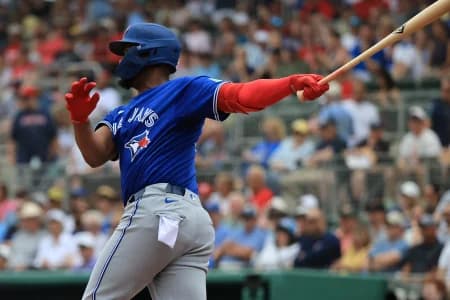 Toronto Blue Jays designated hitter Eloy Jimenez (74) hits an RBI double during the first inning against the Boston Red Sox at JetBlue Park at Fenway South
