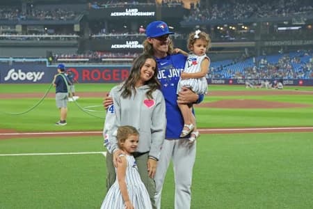 Toronto Blue Jays starting pitcher Kevin Gausman (34) poses for a photo with his family prior to start of a game against the San Francisco Giants at Rogers Centre.
