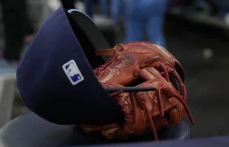 The hat and glove of Toronto Blue Jays shortstop Andres Gimenez (0) in the dug out during an at bat against the Houston Astros at Rogers Centre.