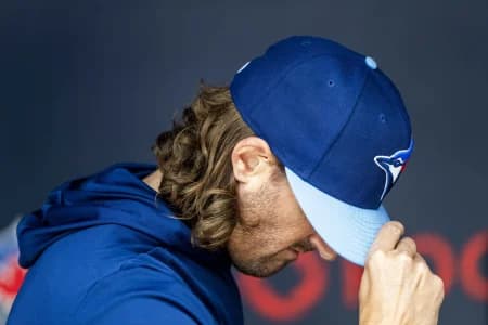 Toronto Blue Jays pitcher Kevin Gausman (34) tips his hat as he leaves the dugout to warm up before playing the St. Louis Cardinals at Rogers Centre
