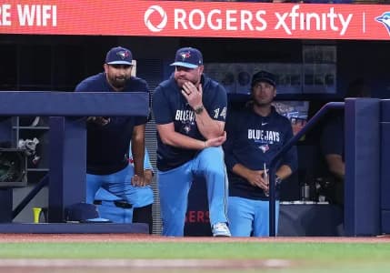 Toronto Blue Jays manager John Schneider (14) watches the play from the dugout against the St. Louis Cardinals during the eighth inning at Rogers Centre.
