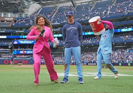 Sportsnet sportscaster Hazel Mae avoids the water bucket by Toronto Blue Jays first baseman Vladimir Guerrero Jr. (27) on shortstop Ernie Clement (28) against the Washington Nationals at the end of the ninth inning at Rogers Centre.