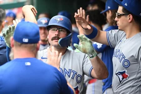 Toronto Blue Jays second baseman Davis Schneider (36) is congratulated by teammates after scoring a run against the Washington Nationals during the eighth inning at Nationals Park.
