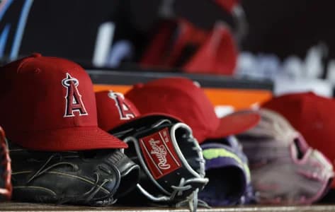 Los Angeles Angels hats and gloves sit in the dugout against the Miami Marlins during the fifth inning at loanDepot Park.