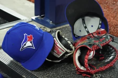 A pair of Toronto Blue Jays hats and gloves in the dugout during the first inning against the Los Angeles Dodgers at Rogers Centre.