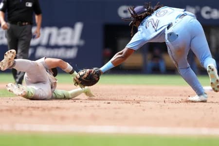 New York Yankees second baseman Jose Caballero (72) is tagged out by Toronto Blue Jays first baseman Charles McAdoo (26) during the seventh inning at Rogers Centre
