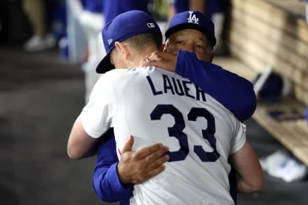 Los Angeles Dodgers pitcher Eric Lauer (33) hugs with manager Dave Roberts (30) after being removed from the game during the seventh inning against the Kansas City Royals at Dodger Stadium