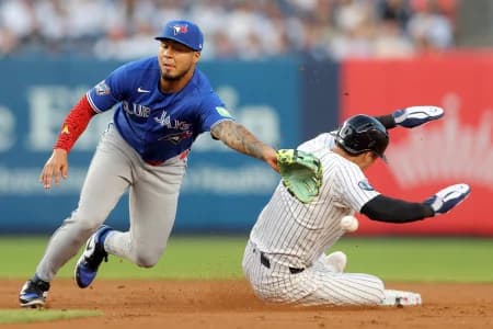 New York Yankees shortstop Anthony Volpe (11) steals second base as the throw goes by Toronto Blue Jays second baseman Lenyn Sosa (50) allowing him to advance to third base during the second inning at Yankee Stadium.