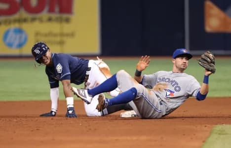 Tampa Bay Rays center fielder Mallex Smith (0) slides into second base as Toronto Blue Jays second baseman Jon Berti (64) attempts to tag him out at Tropicana Field.