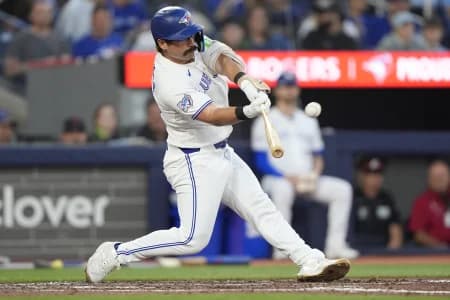 Toronto Blue Jays left fielder Davis Schneider (36) hits an RBI sacrifice fly against the Texas Rangers during the fifth inning at Rogers Centre.
