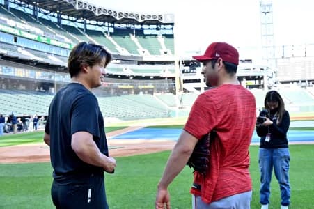 Chicago White Sox first baseman Munetaka Murakami (5) and Los Angeles Angels pitcher Yusei Kikuchi (16) talk to each other prior to a game at Rate Field
