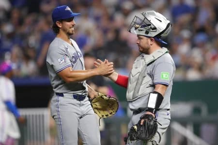 Toronto Blue Jays pitcher Michael Lorenzen (55) celebrates with catcher Alejandro Kirk (30) after defeating the Kansas City Royals at Kauffman Stadium