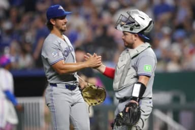Toronto Blue Jays pitcher Michael Lorenzen (55) celebrates with catcher Alejandro Kirk (30) after defeating the Kansas City Royals at Kauffman Stadium