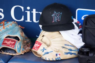 Miami Marlins hat sits in the dugout prior to the game against the Kansas City Royals at Kauffman Stadium.