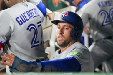 Toronto Blue Jays designated hitter George Springer (4) celebrates in the dugout after scoring against the Kansas City Royals during the seventh inning at Kauffman Stadium.