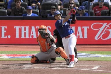 Toronto Blue Jays third baseman Kazuma Okamoto (7) hits a solo home run against the Baltimore Orioles during the fifth inning at Rogers Centre.