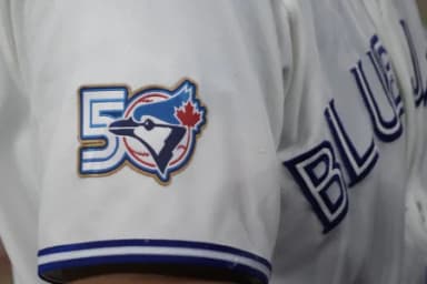 The Toronto Blue Jays 50th anniversary logo displayed on the jersey of third baseman Kazuma Okamoto (7) duringa game against the Athletics at Rogers Centre.