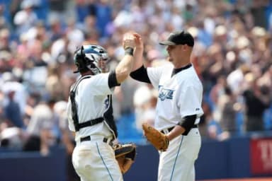Toronto Blue Jays pitcher (40) Brian Wolfe is congratulated by catcher (9) Gregg Zaun after defeating the Minnesota Twins 13-1 at the Rogers Centre in Toronto, ON. Toronto won 13-1