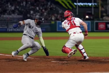 New York Yankees shortstop Jose Caballero (72) slides into home plate to beat a throw to Los Angeles Angels catcher Tyler Heineman (31) to score in the 10th inning at Angel Stadium